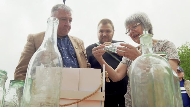 Visitors examining early examples of bottles made at Cannington Shaw.