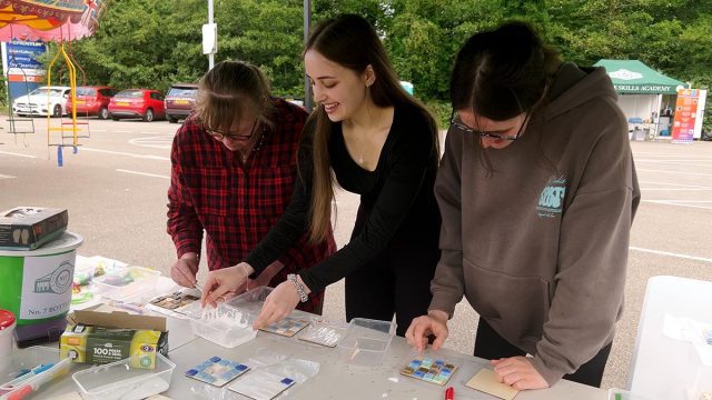 Family tries glass mosaic making